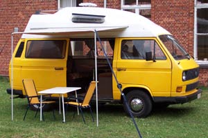 VW T3 camper met uitgezette luifel en tuinmeubelen